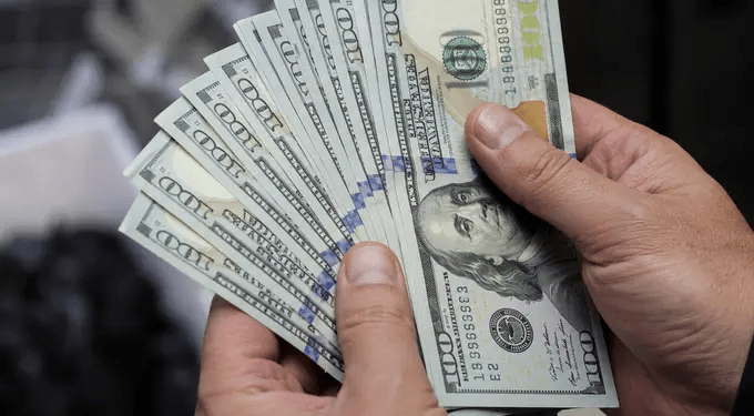 Dollar weakens as US stock futures gain on improved risk sentiment